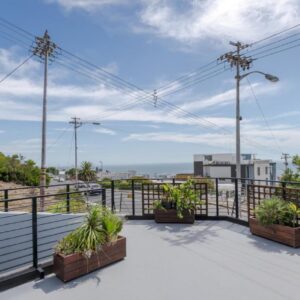 A balcony with potted plants and a railing at Villa on Ocean View in Cape Town