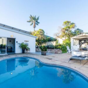 A swimming pool in the backyard of a house at Villa Palmera in Mossel Bay
