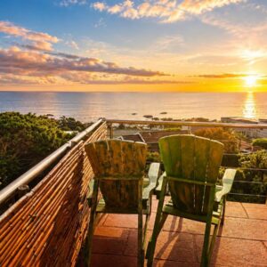 Two chairs on a balcony with a view of the ocean at VistaBlu Camps Bay in Cape Town