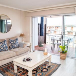 A living room with a couch and a table at Waterfront - Knysna Quays Accommodation- Family Apartments in Knysna