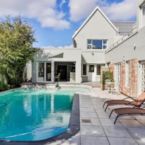 A swimming pool in the backyard of a house at Wholeness Accommodation in Hermanus
