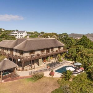 An aerial view of a house with a swimming pool at Wild Rose Country Lodge in Noordhoek