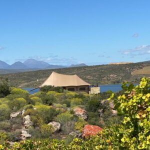 A large tan building with a view of a mountain at Yamu Lifestyle Resort in Clanwilliam