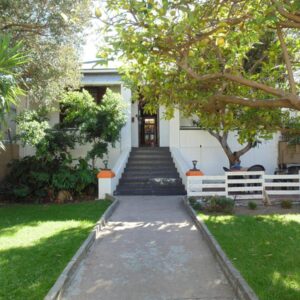 A house with a staircase leading to the front door at Zebra Crossing Backpacker in Cape Town