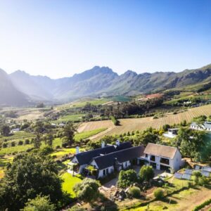 An aerial view of a farm with mountains in the background at Zeven Eike Homestead in Stellenbosch