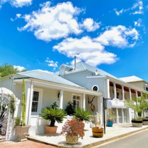 1 Royal Street Guesthouse: a white house with potted plants on a street