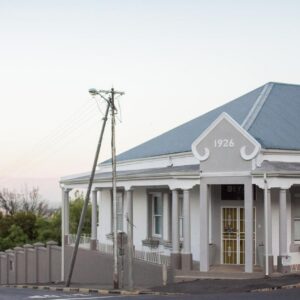 1926 Self Catering: an old white house with a fence in front of it