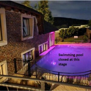 19th Hole Golf Villa Guesthouse: a house with a swimming pool lit up at night