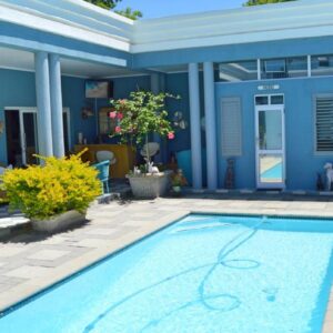 1AA Wilhelmina Luxury Suites: a swimming pool in front of a house