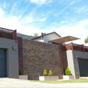 20 On Somerset: a house with a brick wall and a garage