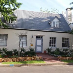 3 on Roux: a white house with a blue door