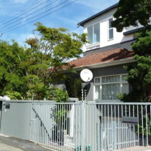 4 on Highworth Apartments and Studios: a white fence in front of a white house