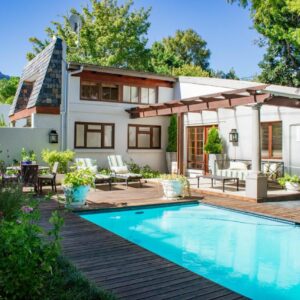 5 Seasons Guest House: a backyard with a swimming pool and a house