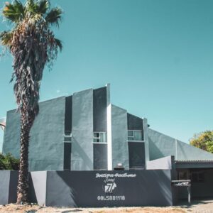 7 Eland Boutique Guest House: a building with a palm tree in front of it