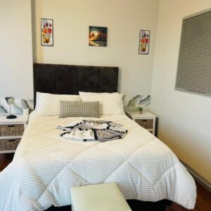 A guesthouse & Dormitory beds Claremont: a bedroom with a bed with a white comforter