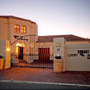 A Smart Stay Apartments: a house with a gate in front of it