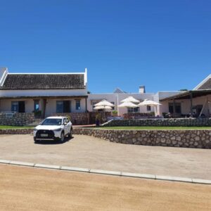 Abalone Guesthouse: a white car parked in front of a house
