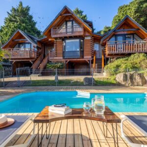 Abalone Lodges: a log home with a pool and a house