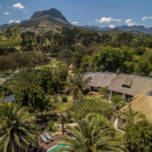 Africa Lodge: an aerial view of a house with trees and mountains