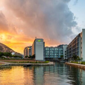 aha Harbour Bridge Hotel & Suites: a view of a city with a river and buildings