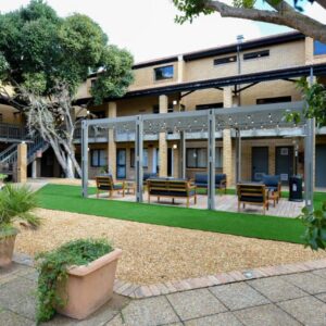 All Africa House (University Of Cape Town): a courtyard of a building with benches and chairs