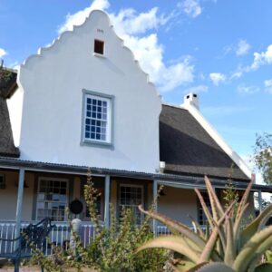 Aloe Guest House: a white house with a gambrel roof