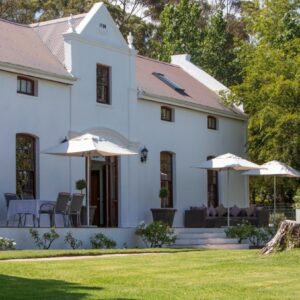 Andreas Country House: a white house with umbrellas on the lawn