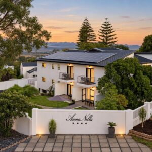 AnnaNella Boutique Hotel: a white house with a white fence and trees