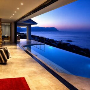 Aqua Terra Boutique Guesthouse - Simon's Town, Cape Town: a house with a swimming pool with a view of the ocean