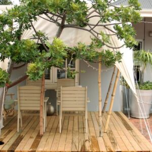 At The Loerie: a gazebo with chairs and trees on a deck