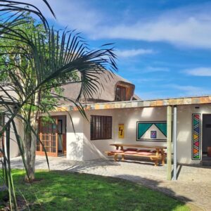 Badger's Lodge: a house with a palm tree in front of it