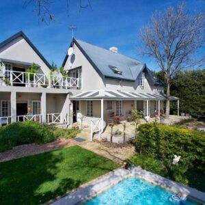 Baruch Guest House Rhodes: a house with a swimming pool in front of it