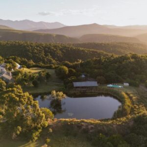 Belle Balance Bush Lodge: an aerial view of a house and a lake in the mountains