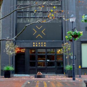 BlackBrick Foreshore: a black brick building with a black and gold store