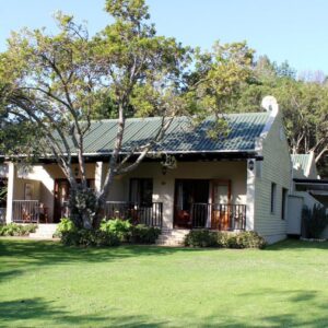 Blackwaters River Lodge, Knysna: a house with a green lawn in front of it