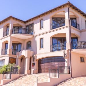 Blue Horizon Guest House: a large house with balconies and a driveway