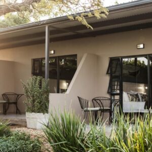 Bona Vista Self-Catering Accommodation: a house with chairs and tables on a patio