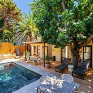 Botany House Boutique Retreat: a house with a swimming pool and a tree