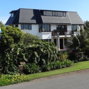 Braeview Guest House: a house with two flags on the side of a road