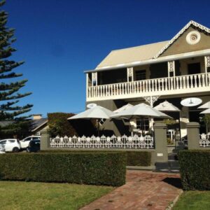 Bredasdorp Square: a large house with umbrellas in front of it