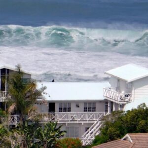 Brenton Beach House: a large wave in front of a white house