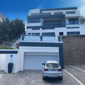 Camps Bay Blue Self-Catering Studios: a car parked in front of a white house