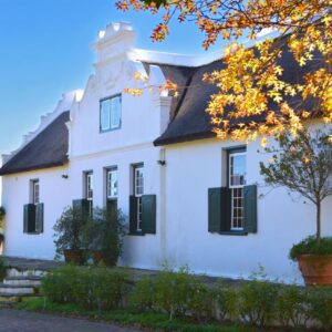 Cape Dutch @ Keerweder: a white house with black shutters and a tree