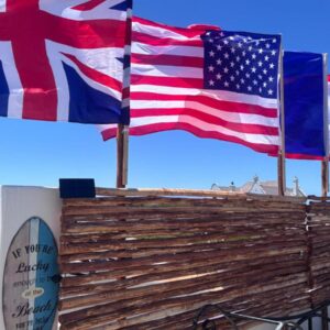 Cape Nomads: three flags are flying on top of a building