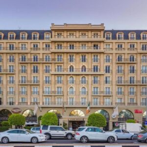 Cape Royale Apartments with Cape Finest: a large building with cars parked in front of it