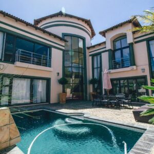Castellon Boutique Hotel: a house with a swimming pool in front of it