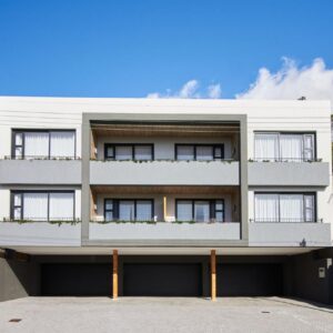 Central Beach Villas: a large white building with windows on a street