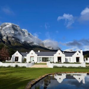Chambray Estate - The Terraces in the Vines: a white house with a mountain in the background