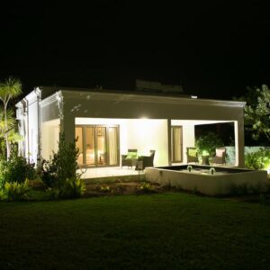 Christofphs: a white house with a tub in a yard at night