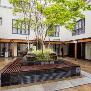 Church Street Luxury Apartments: an empty courtyard with a tree in the middle of a building